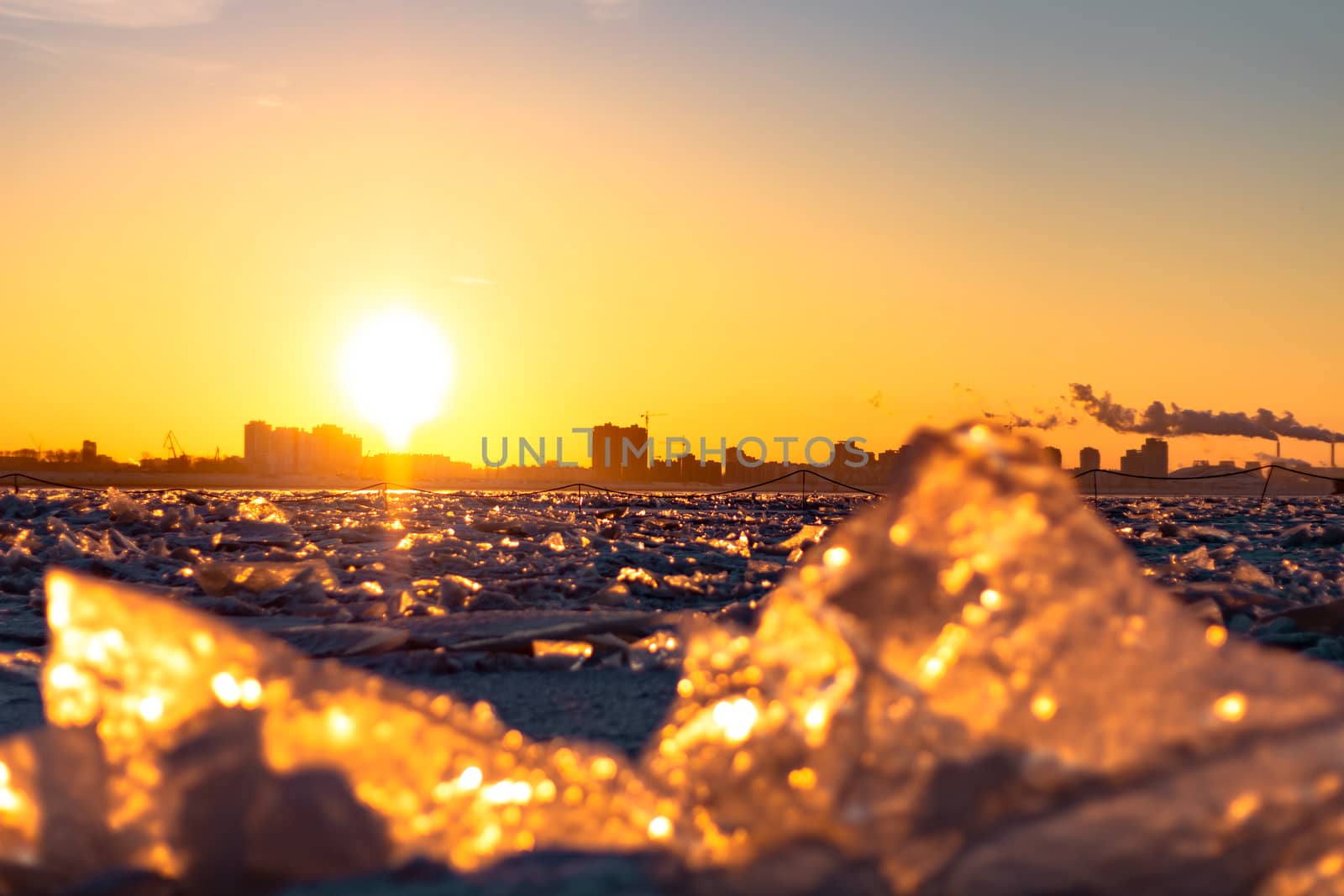 View of the city of Khabarovsk from the middle of the frozen Amur river. Factories on the horizon.