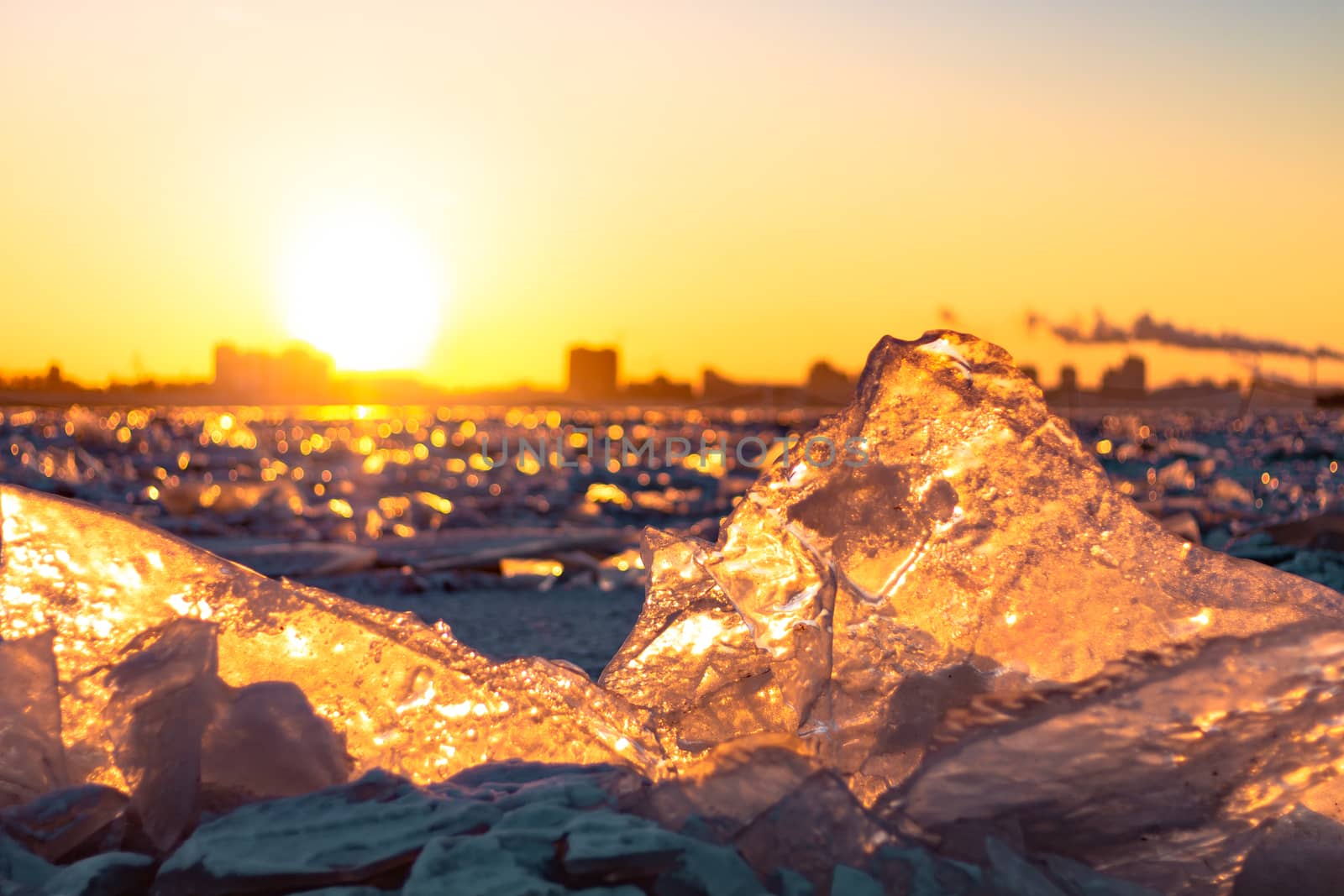 View of the city of Khabarovsk from the middle of the frozen Amur river. Factories on the horizon.