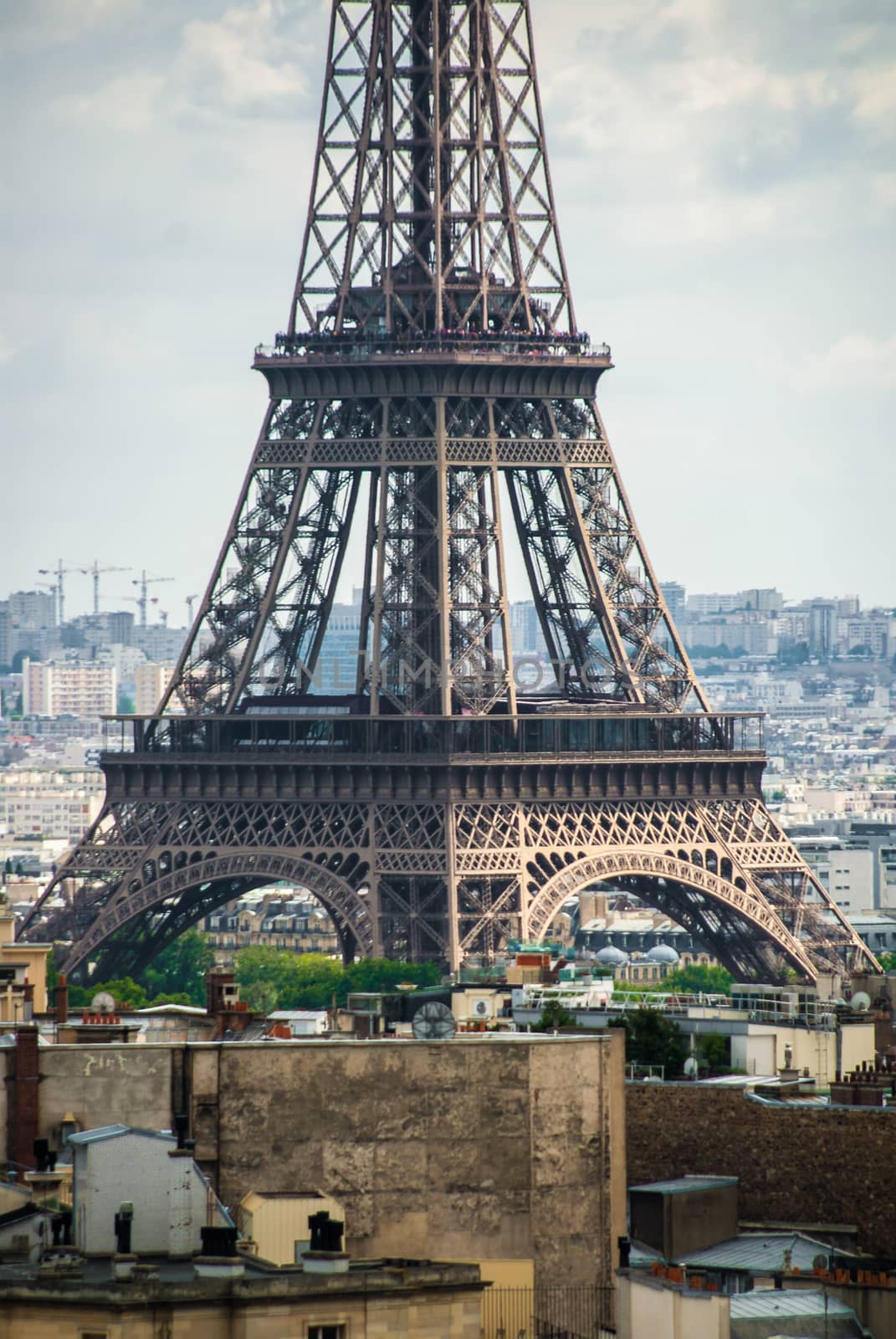 Eiffel Tower in center of Paris big city cloudy sky by MXW_Stock