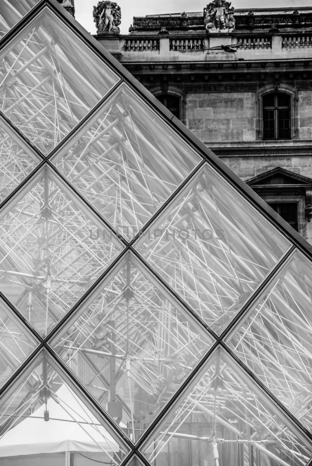 Glass pyramid at Louvre Paris Pyramide du Louvre black and white by MXW_Stock