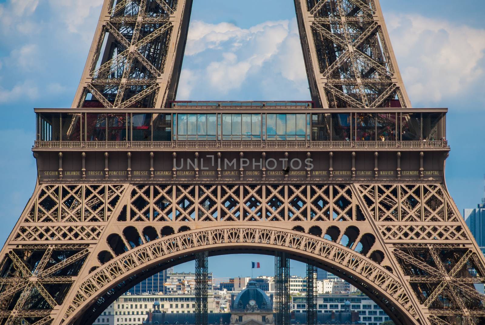 Lowest arch of Eiffel Tower Tour Eiffel blue sky steel structure by MXW_Stock