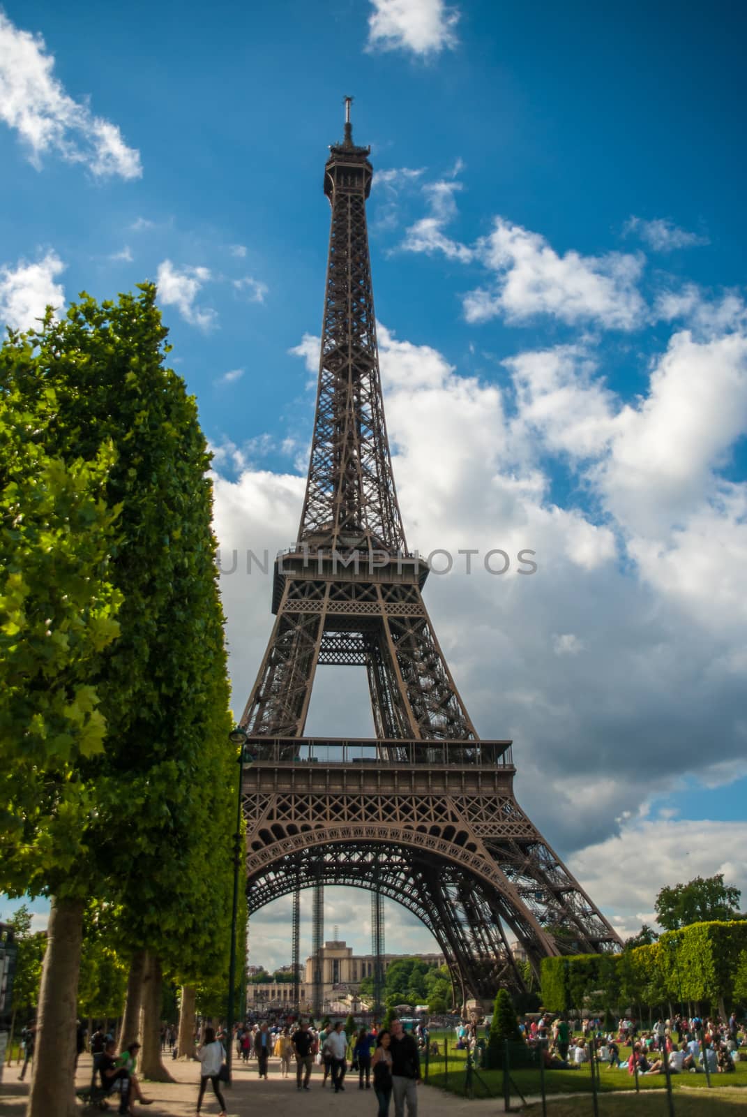 Park in front of Eiffel Tower Tour Eiffel blue sky clouds by MXW_Stock