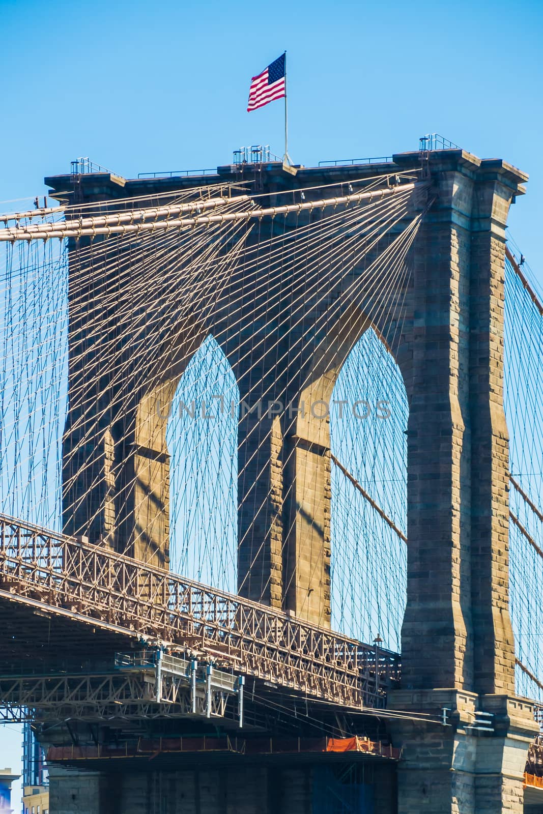 American flag on top of Brooklyn Bridge New York by MXW_Stock