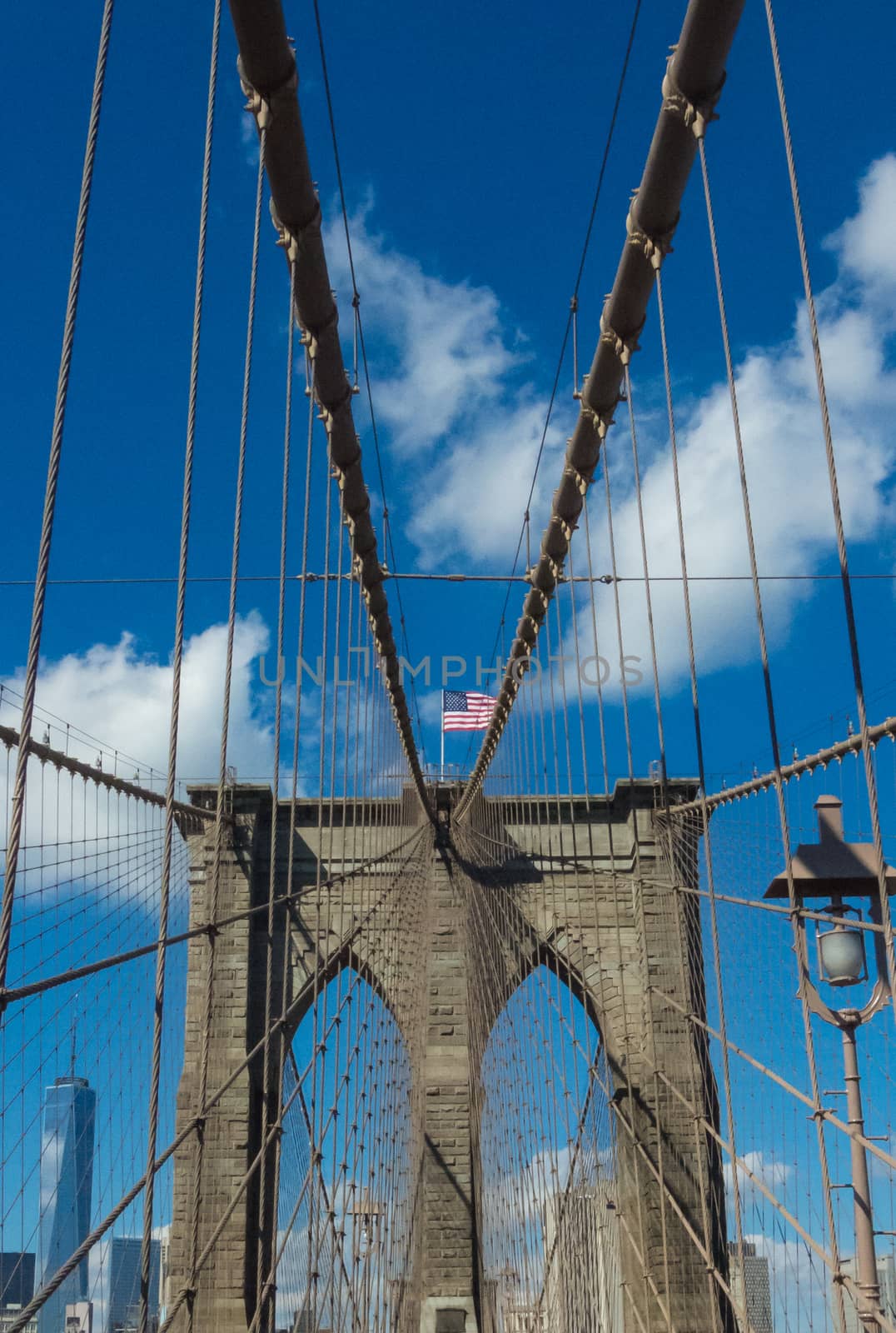 Central view standing on Brooklyn bridge American flag steel rop by MXW_Stock
