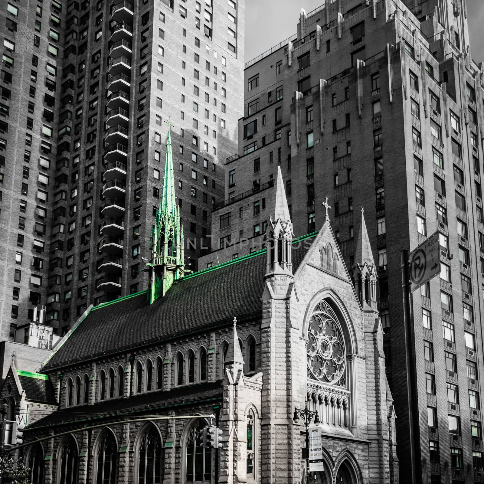 Church in New York Manhattan caught by the modern skyscrapers black white green