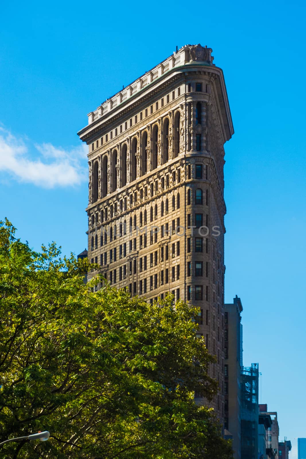 Flat Iron building New York Manhattan in sun blue sky by MXW_Stock