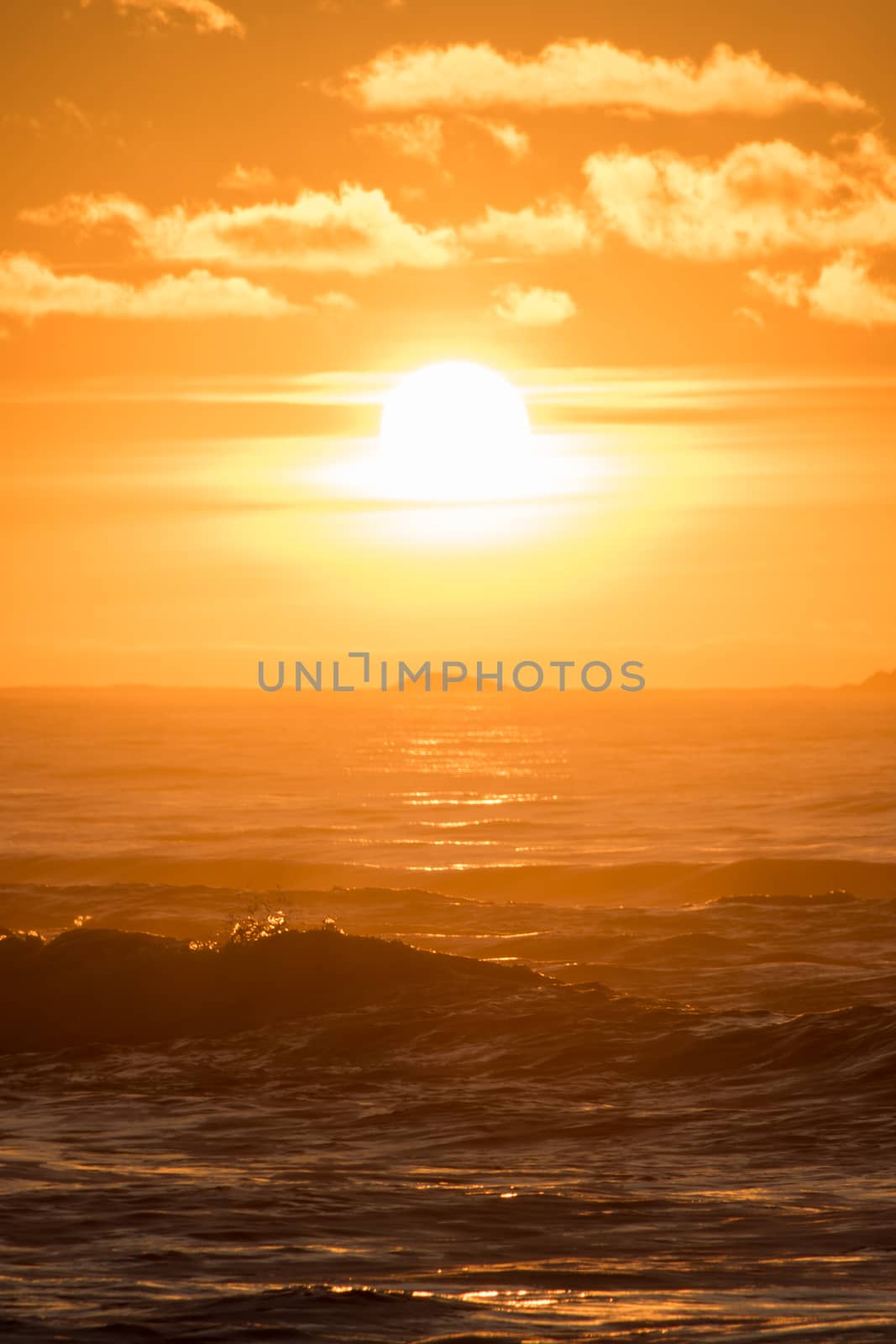 Sunset Hellstø beach with lighthouse yellow red Norway by MXW_Stock