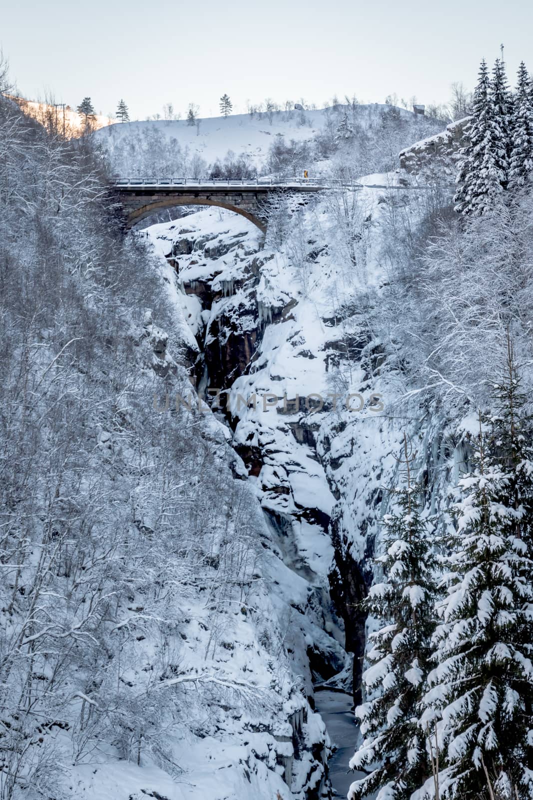 Bridge over snow canyon mountains by MXW_Stock
