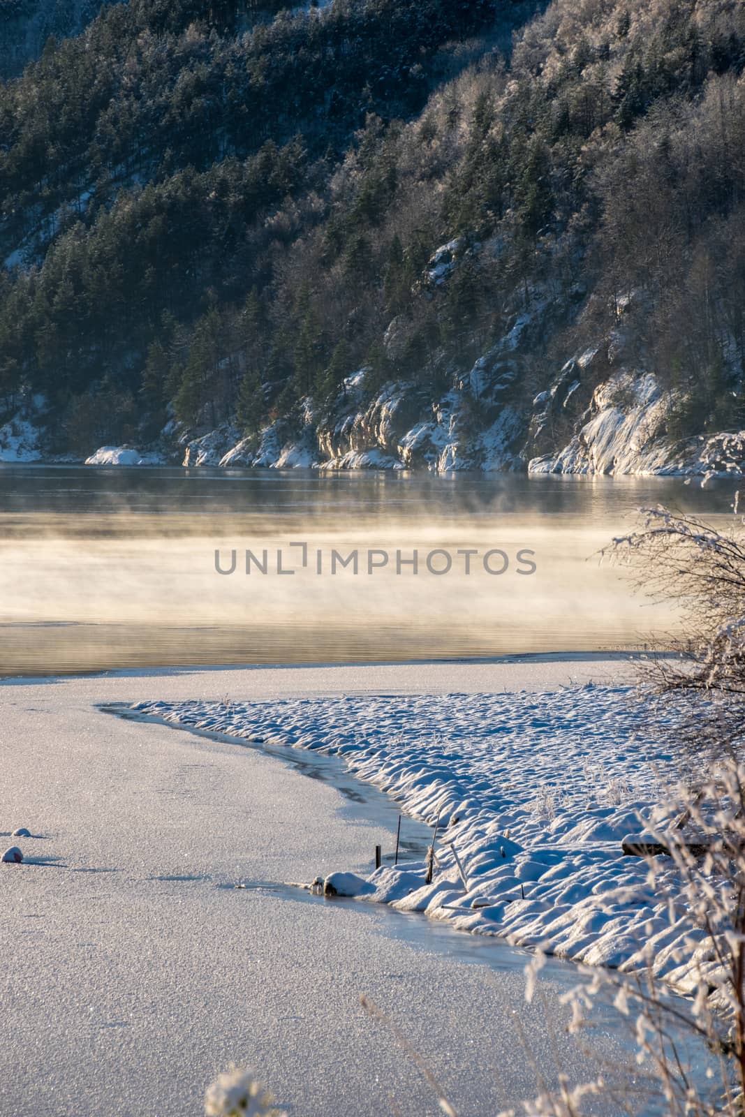 Steaming water frozen lake winter sunny