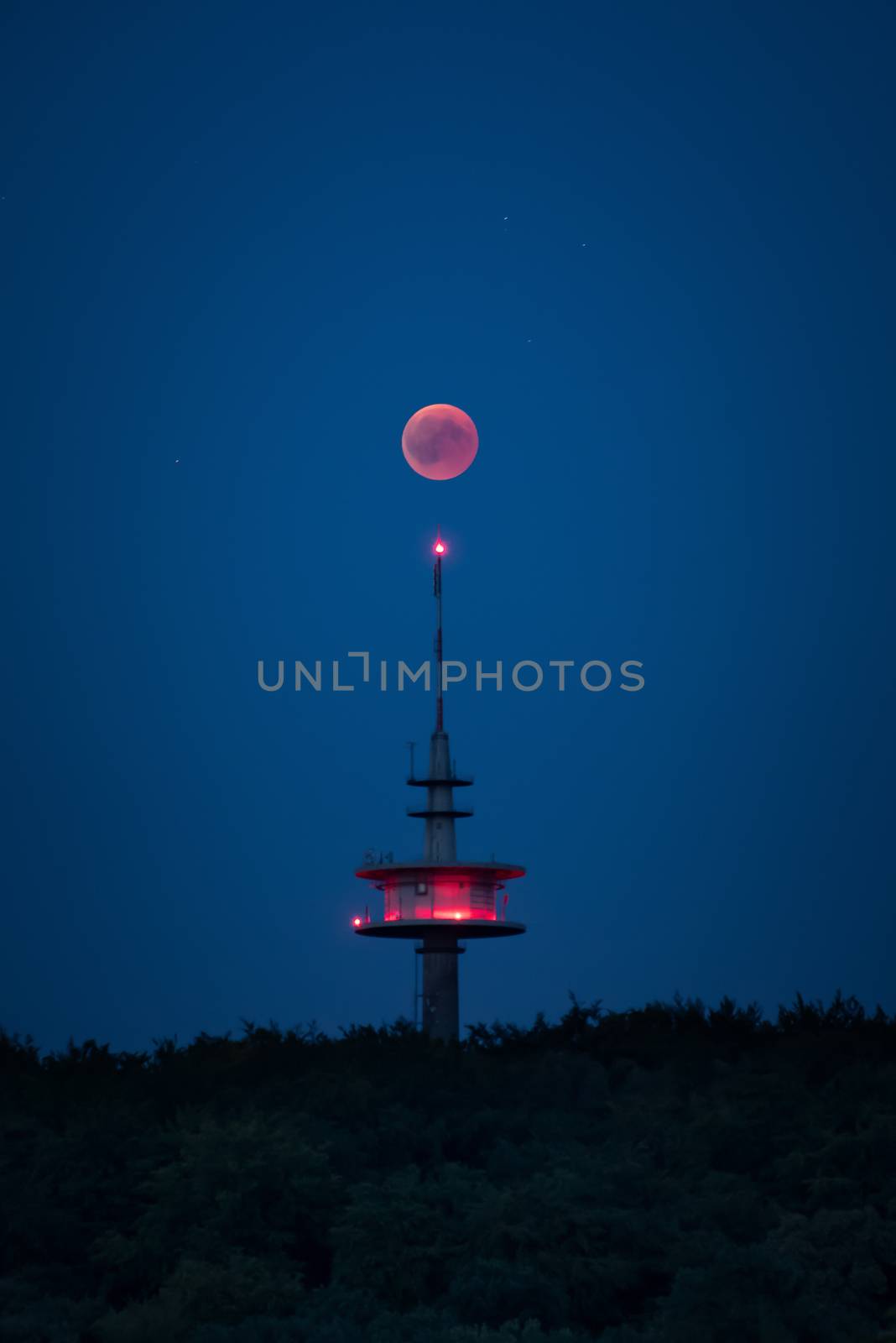 Blood moon red shining right above broadcasting tower germany