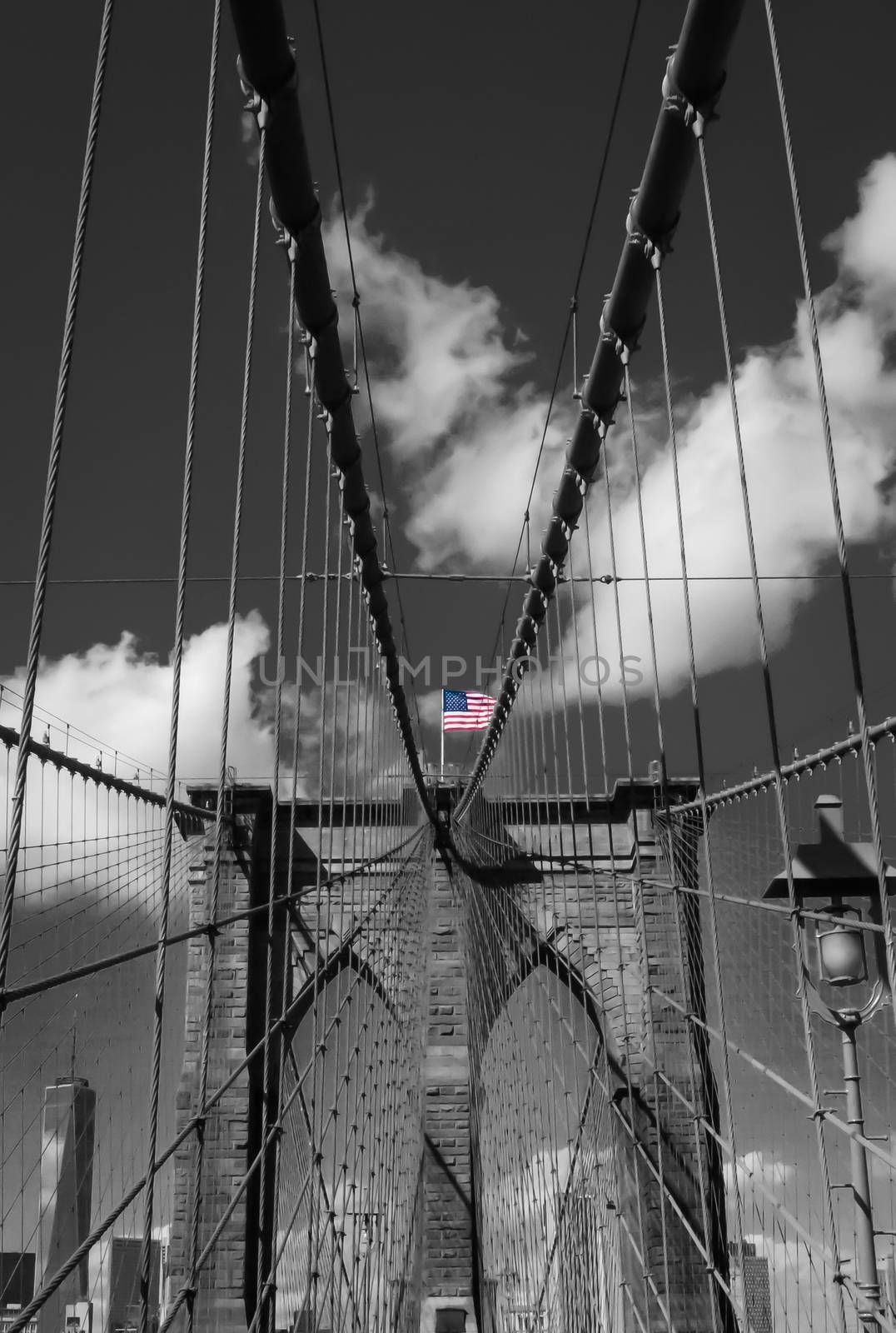 Central view standing on Brooklyn bridge American flag steel ropes