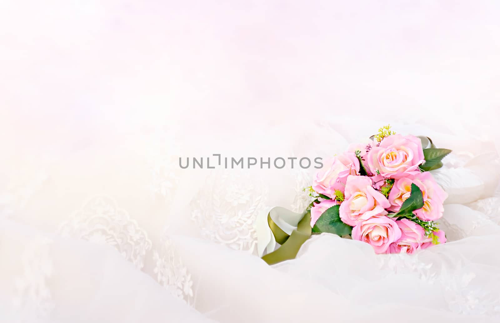 Beautiful bouquet of fresh roses on a white drapery