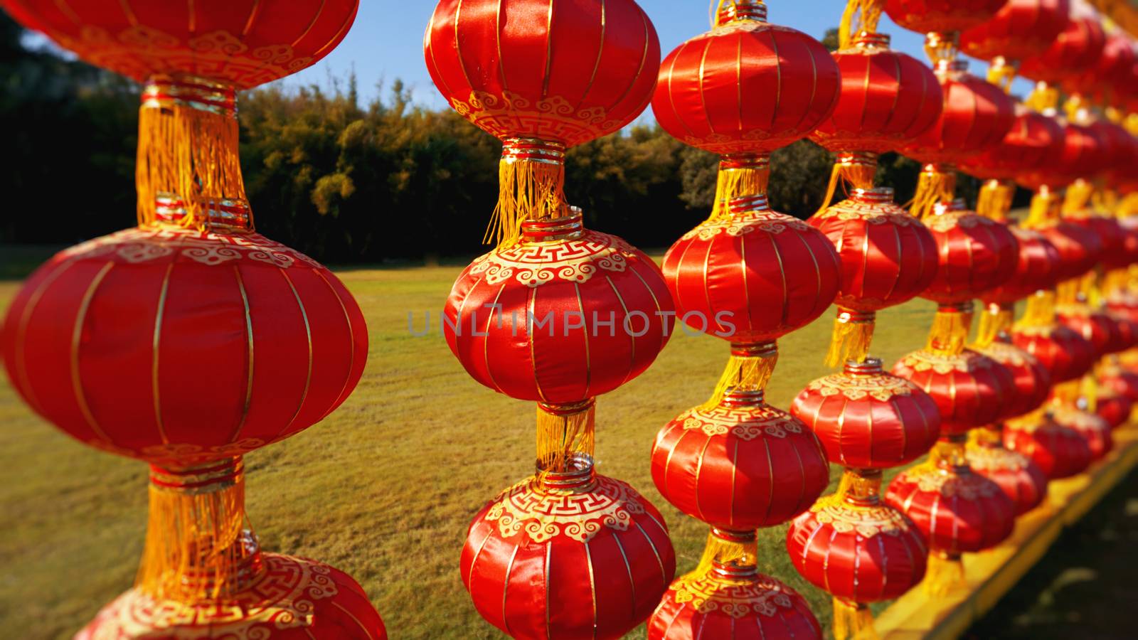 Red Chinese lantern hanging in a row during day time for Chinese new year or Luna New Year celebration in China - Hainan.