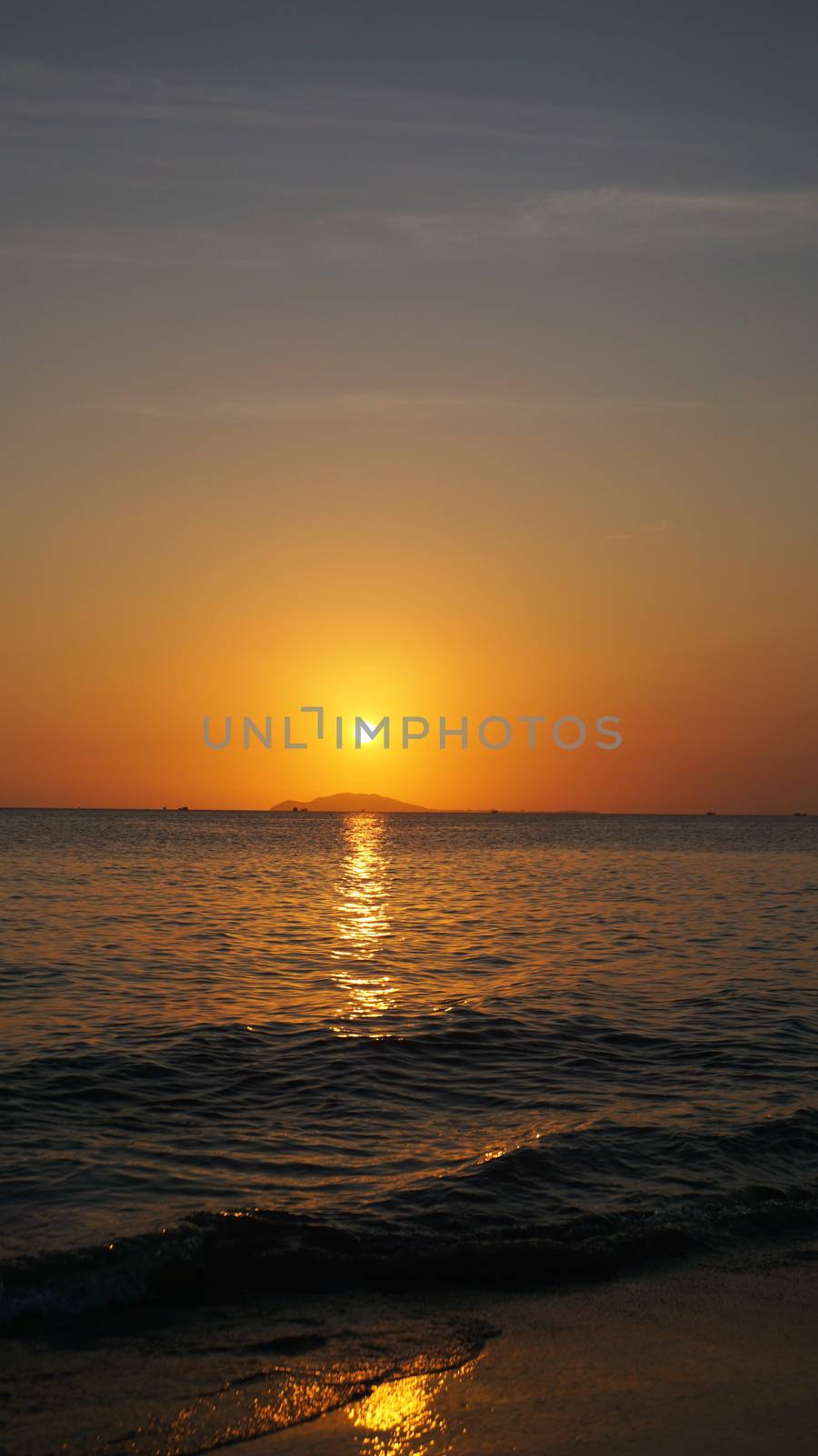 Bright sunset under the sea with yellow red gradient colors - Vertical