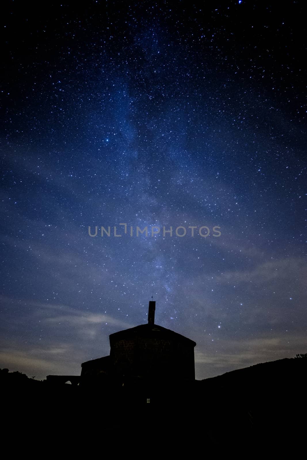 Milky way comming from Eunate church in a cloudy night near Pamplona, Spain by mikelju