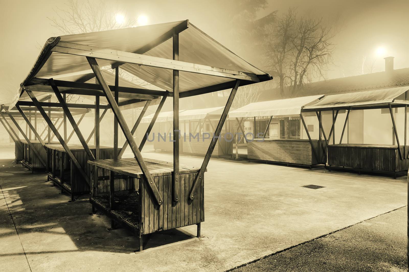 empty open market stall on foggy night