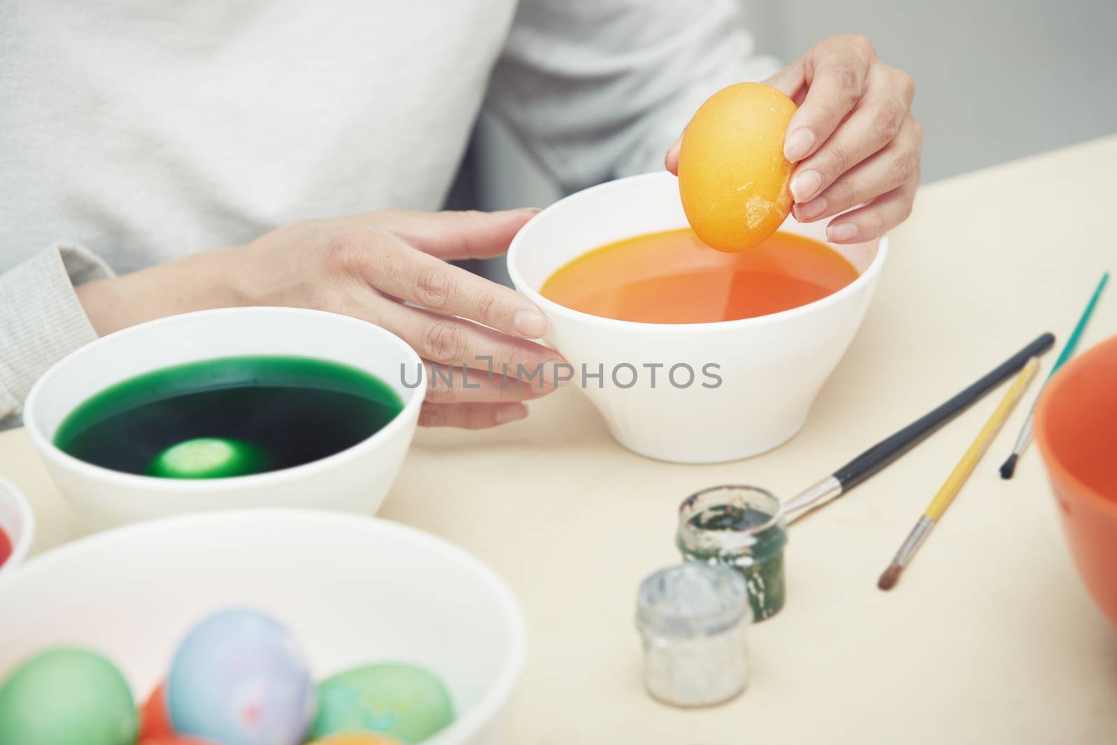 Woman preparing and dying Easter eggs