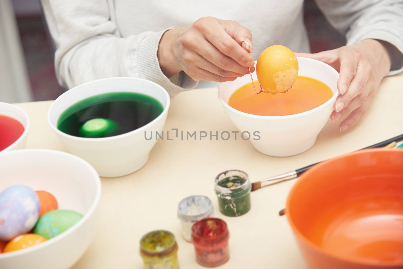 Woman preparing and dying Easter eggs