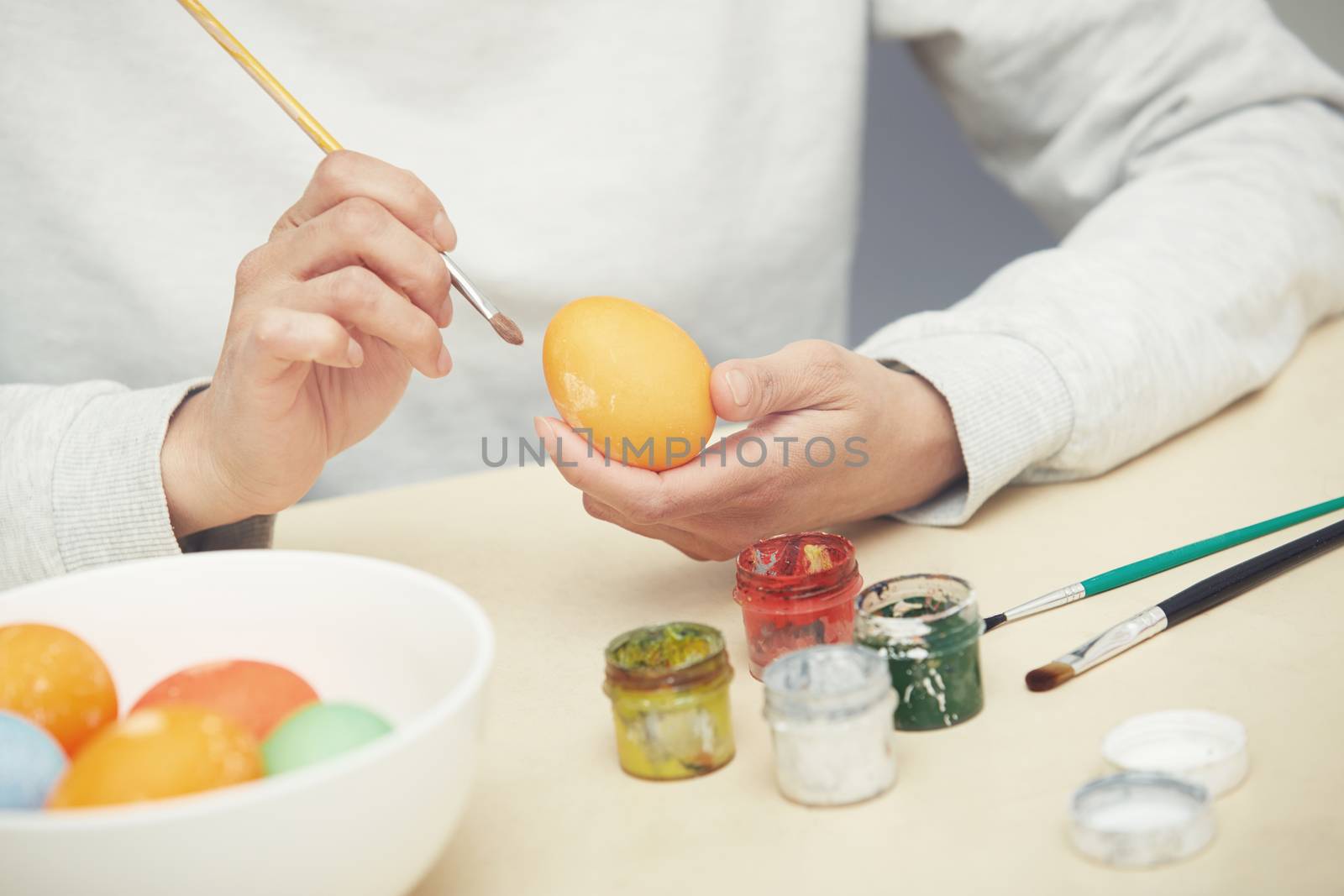 Woman preparing and dying Easter eggs