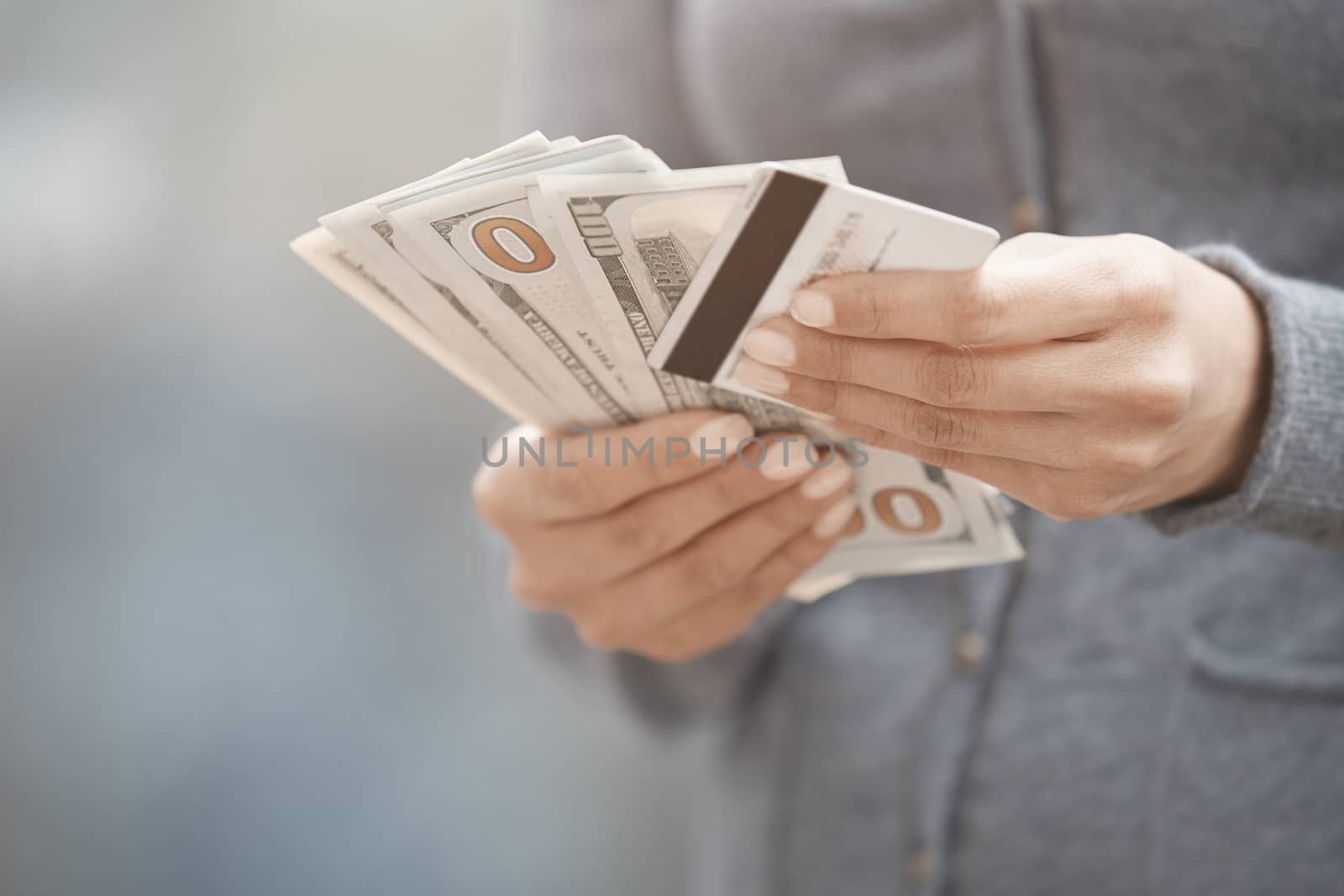 Woman holding cash money and credit card