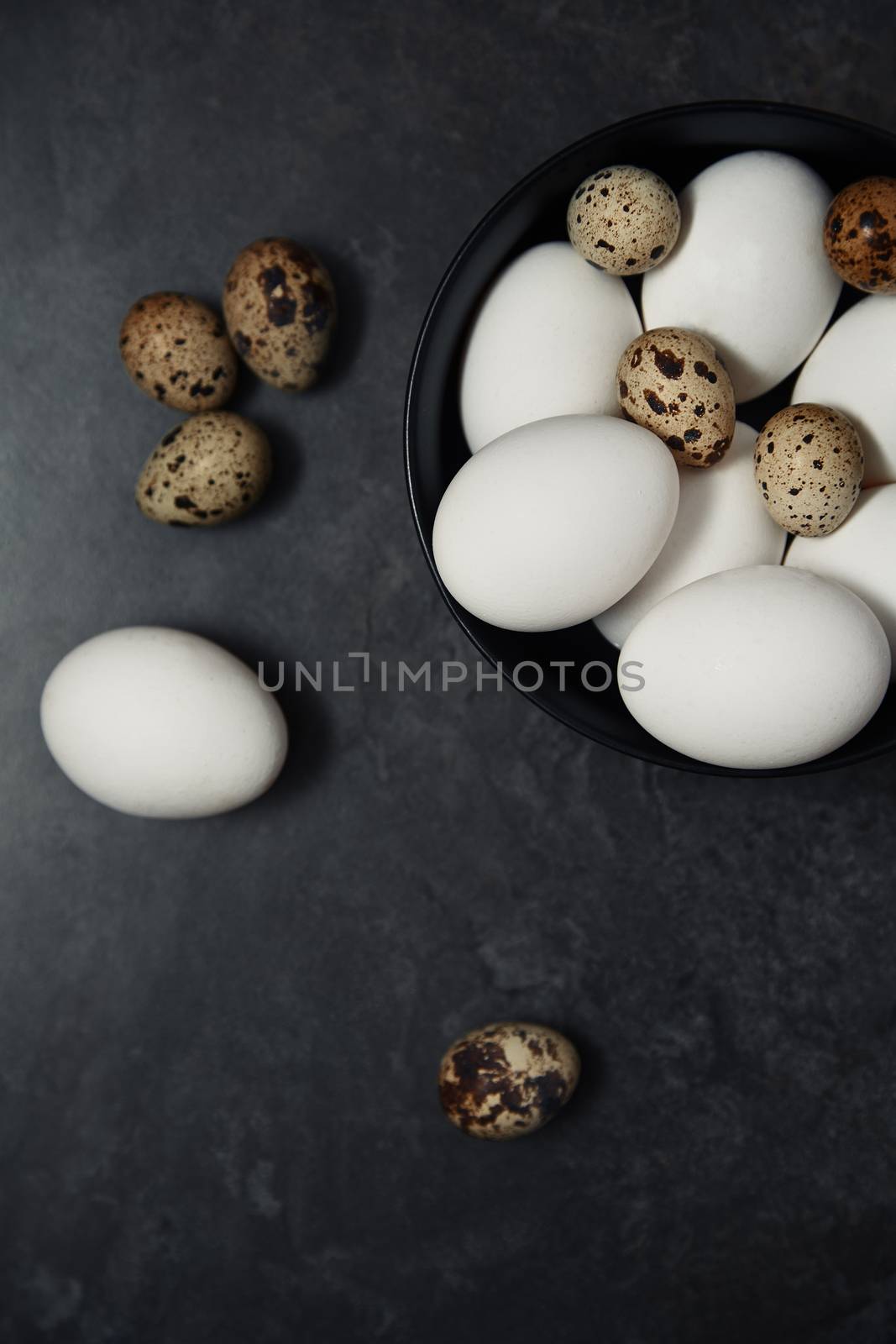 Quail and chicken eggs on a table