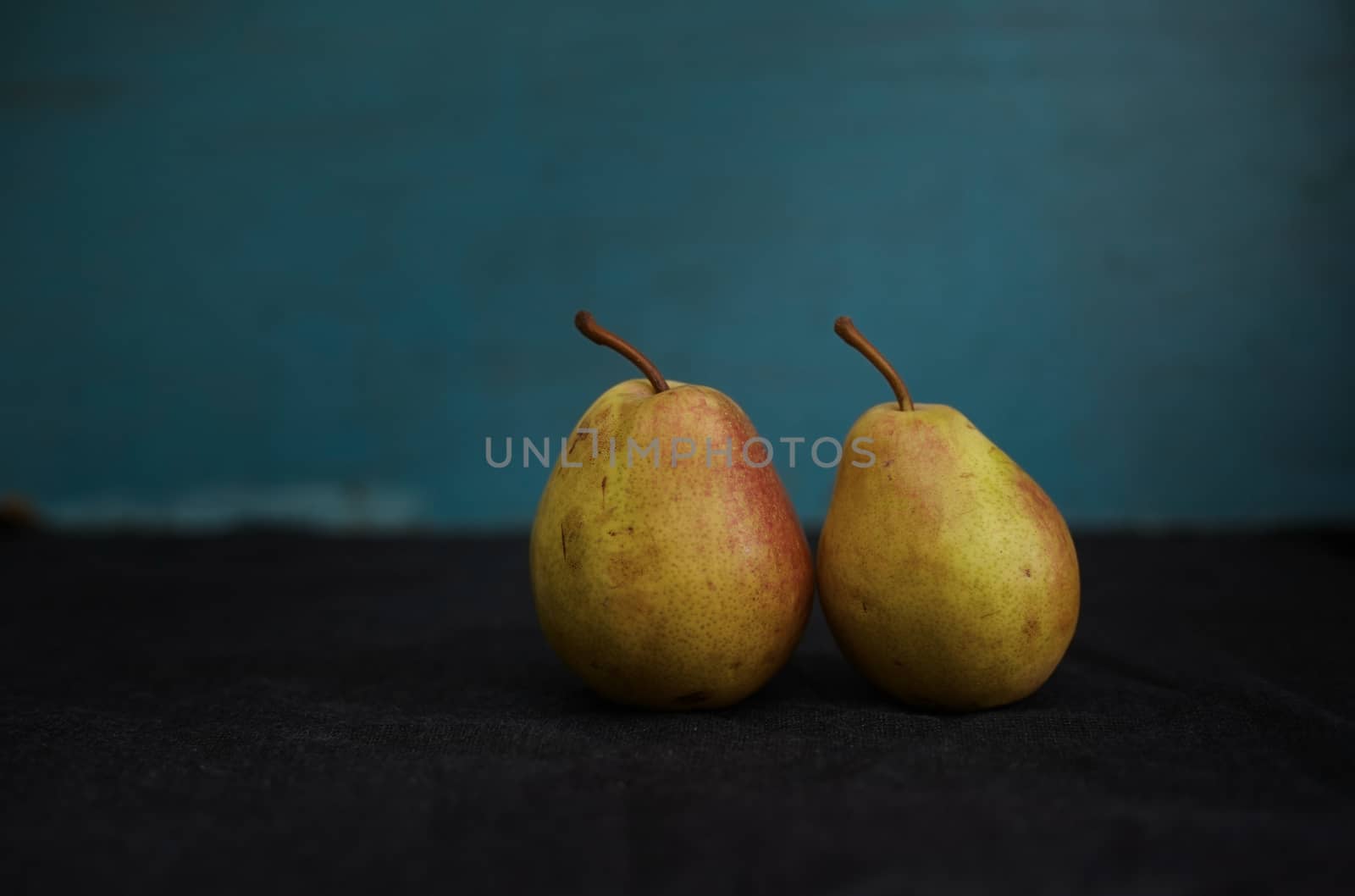 Two fresh pears on a table. Close-up view