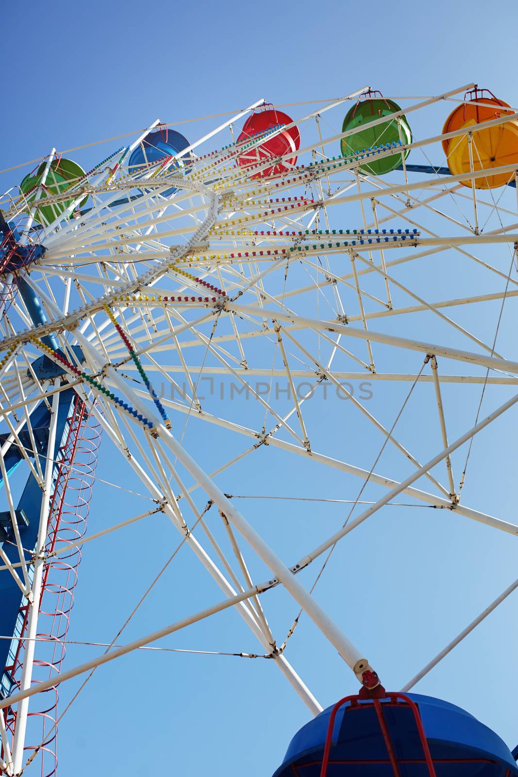 Ferris wheel in public amusement park. Low angle view