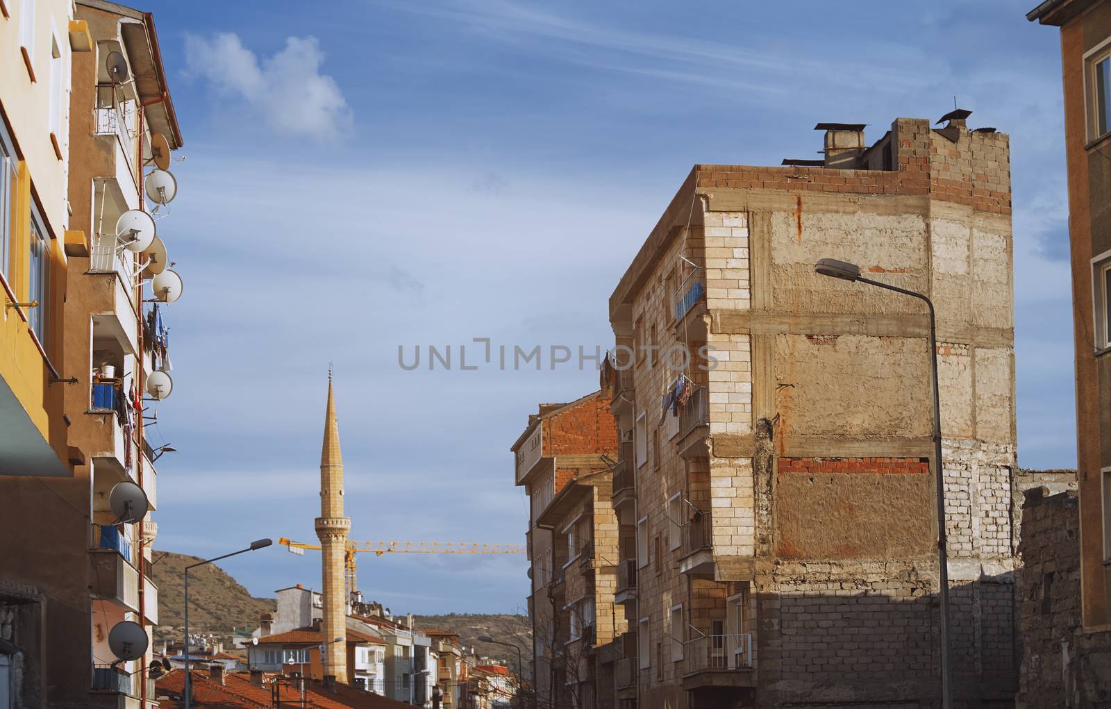 Goreme town with mosque and residential buildings in Cappadocia region, Turkey