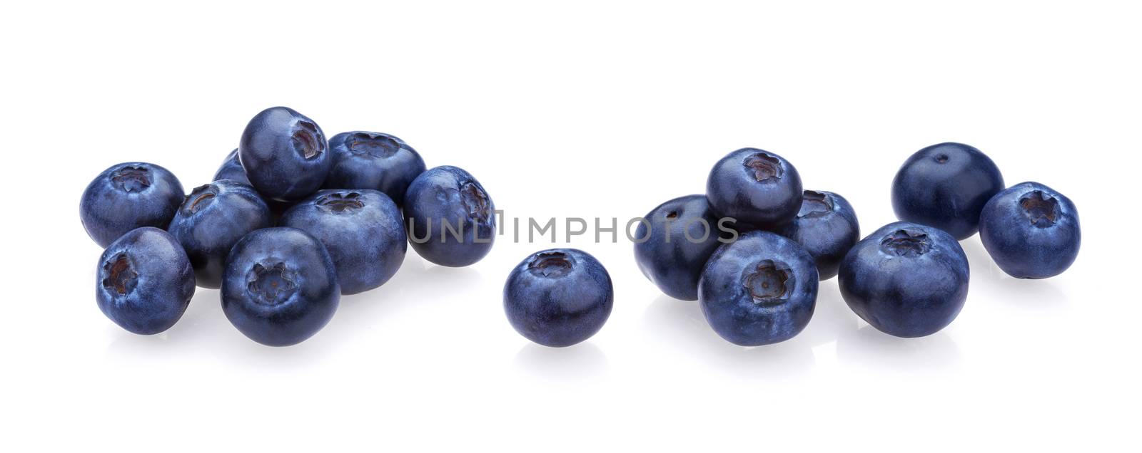 Blueberry isolated on white background. A pile of fresh blueberries, fresh wild berries, ideal for use in packaging, close-up