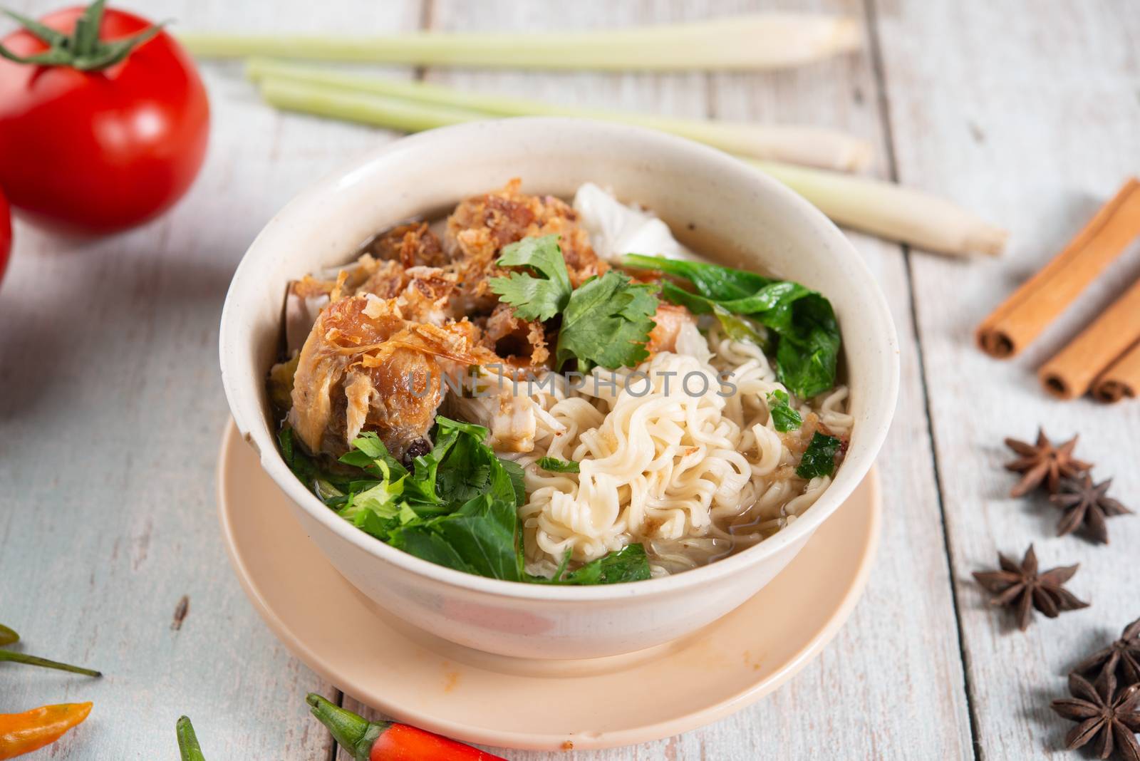 Asian ramen noodles soup and chicken in bowl on dark background. 