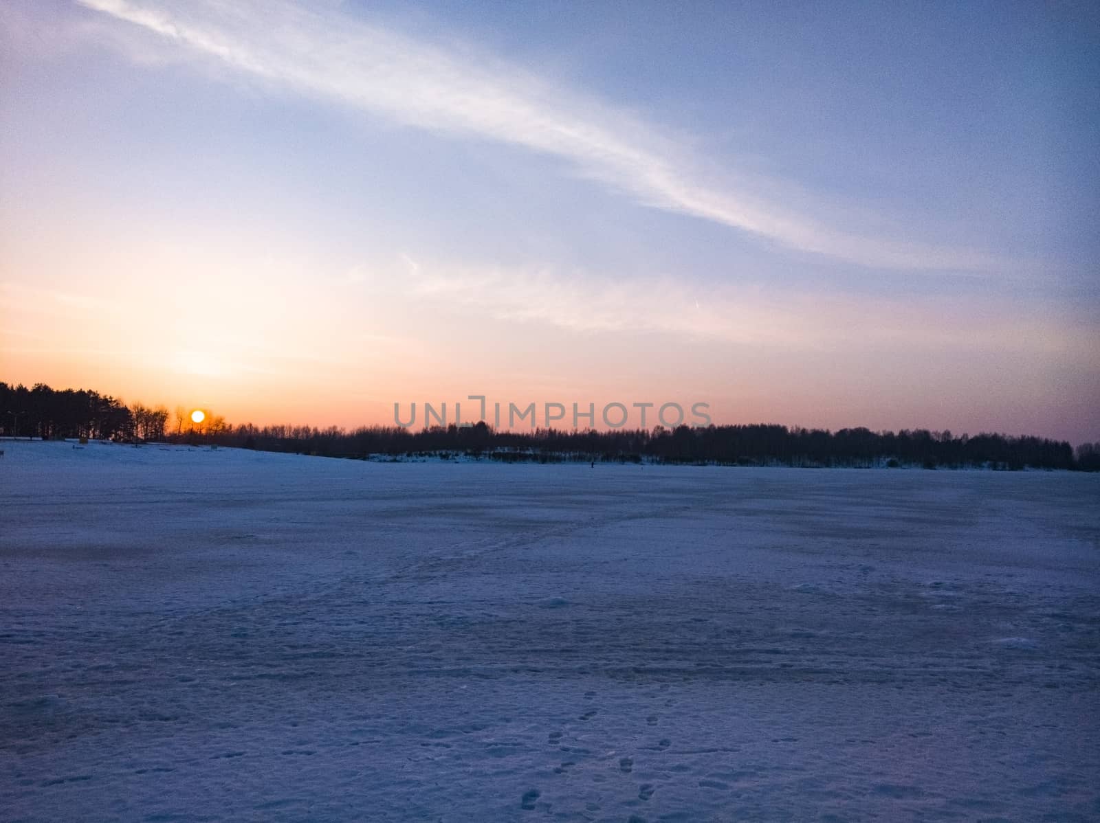 Beautiful sunset on the lake on a frosty day