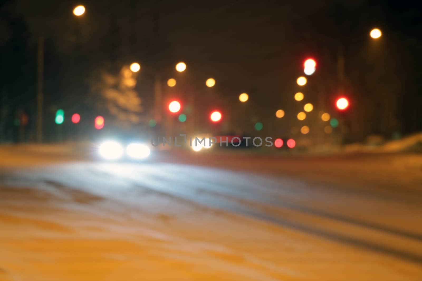 Cars on the winter road with snow. Dangerous car traffic in bad weather with bokeh at night to use background. by kip02kas