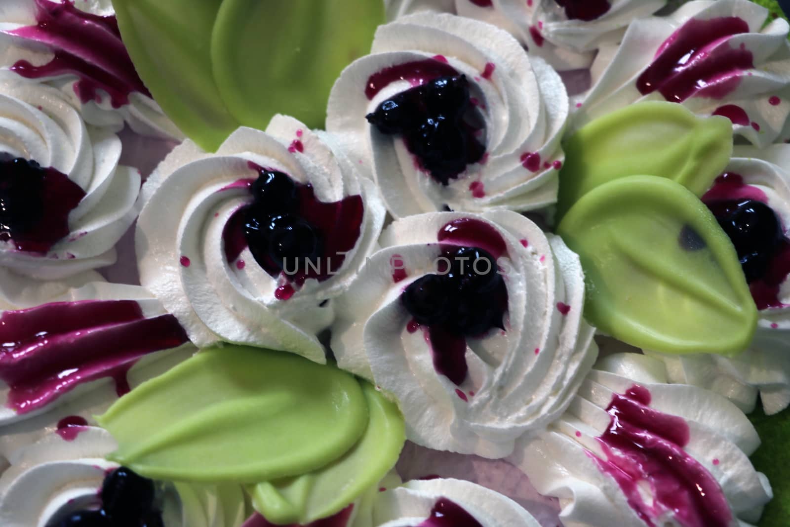 Cake with coconut flakes and currants in cream, view from the top