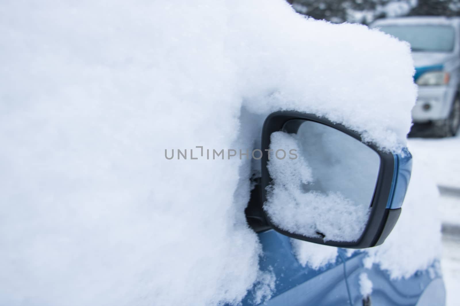 Closeup of a car covered in snow. by kip02kas
