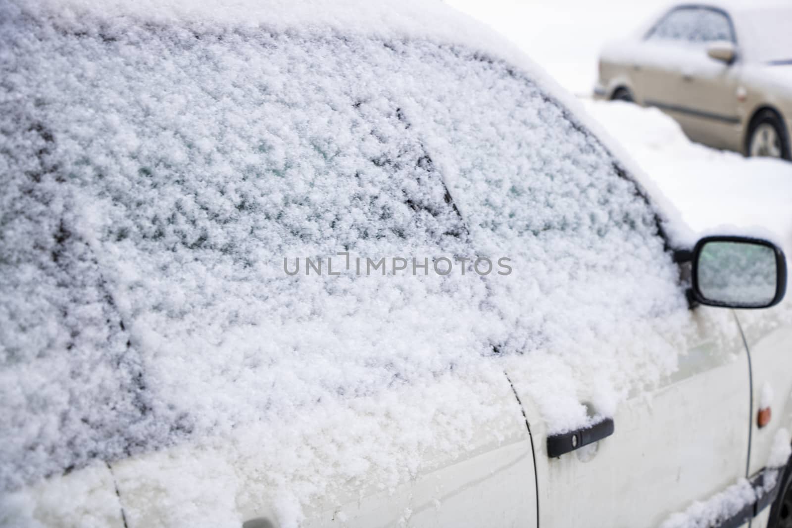 Winter city, drifts on the roads, cars in the snow and snow drifts