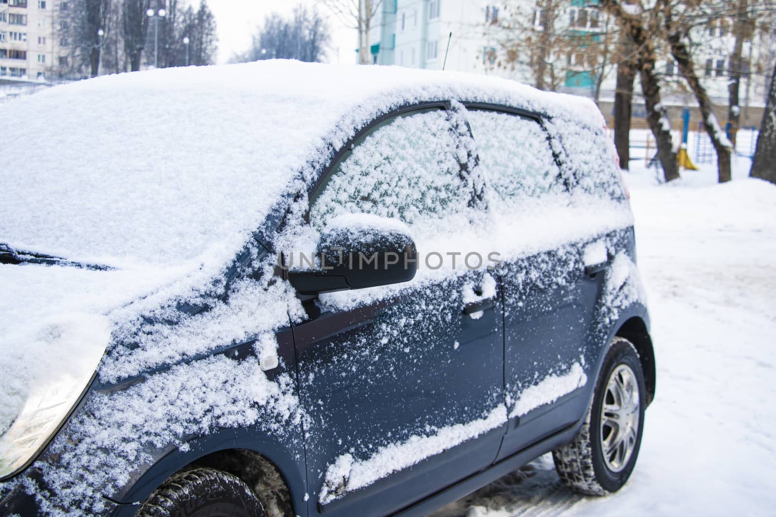 view of snow covered cars in parking lot. by kip02kas