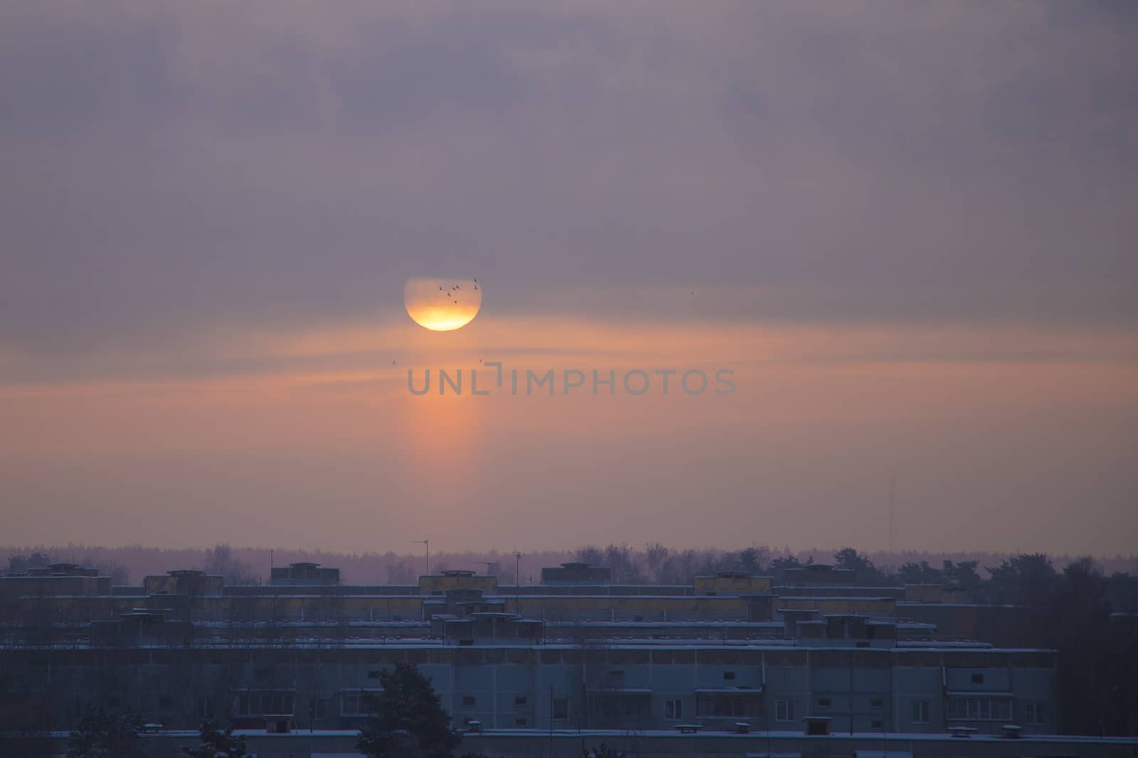 The sun rises on a frosty misty morning over the city. by kip02kas