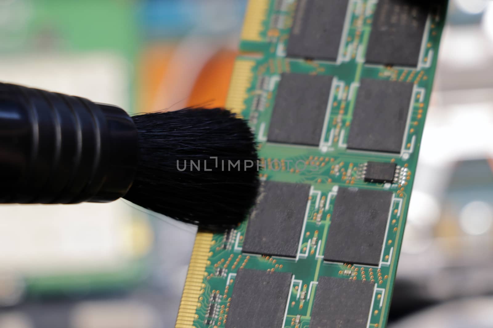 The service center worker cleans dust at Random Access Memory or electronic board RAM