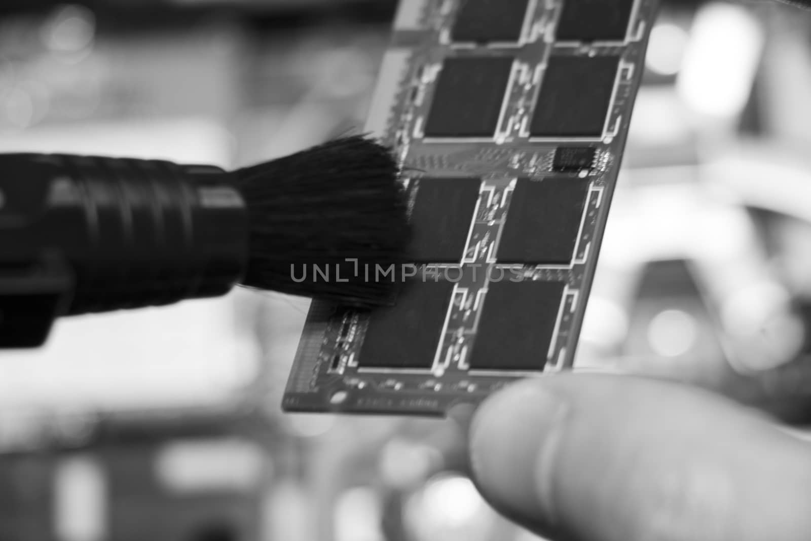 The service center worker cleans dust at Random Access Memory or electronic board RAM