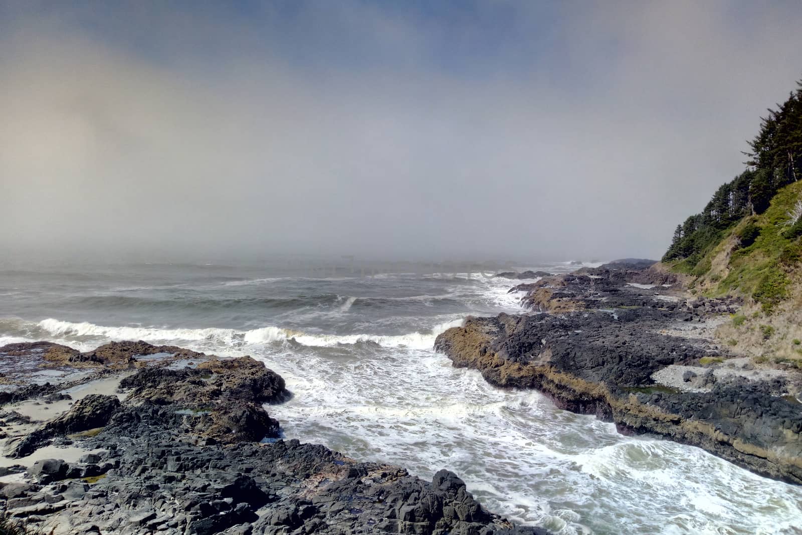 Incoming surf tide churns in narrow channel of Thor's Well on Cape Perpetua, Oregon coast