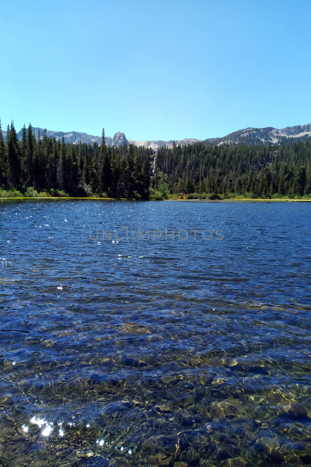 Clear lake high in the mountains on a sunny day. by kip02kas