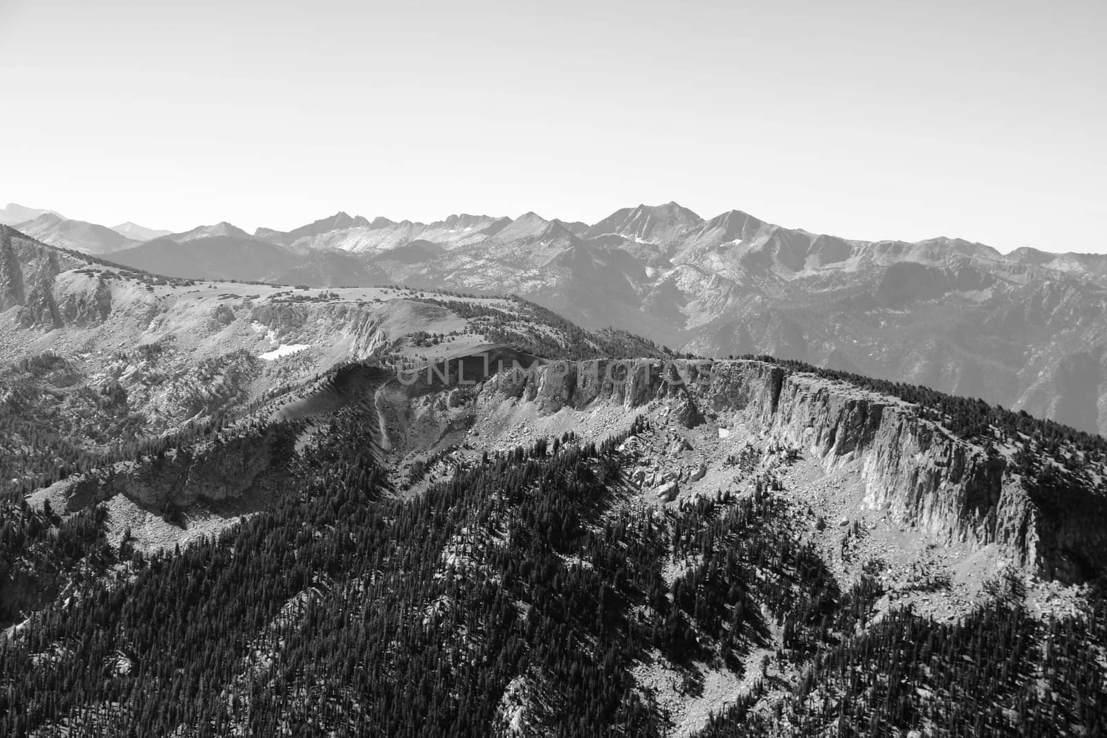 View from the top of the mountain or Olympus to the peaks against the background of clouds and sky, black and white version