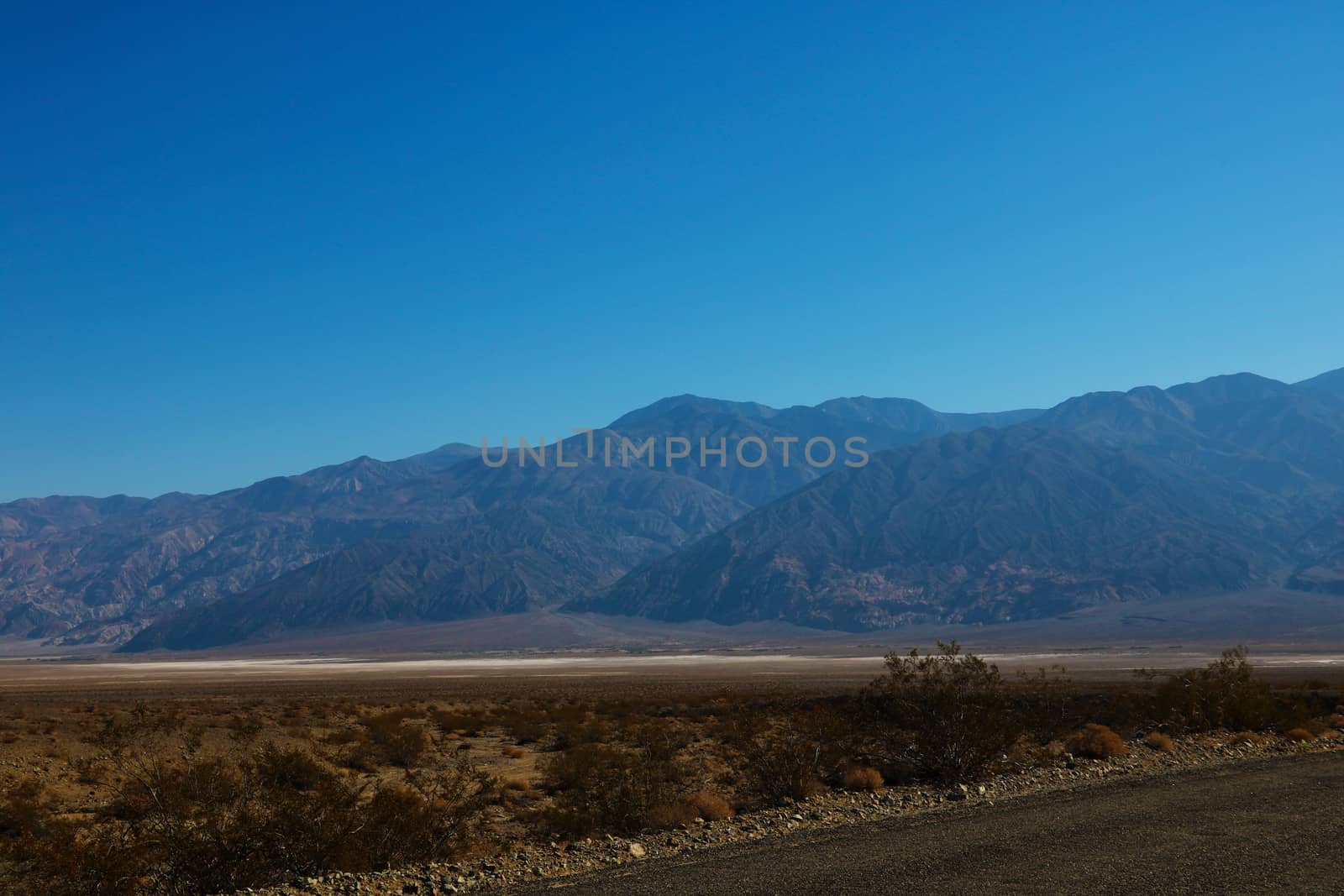 The road through Death Valley National Park, with the Panamint Mountains in the background. by kip02kas