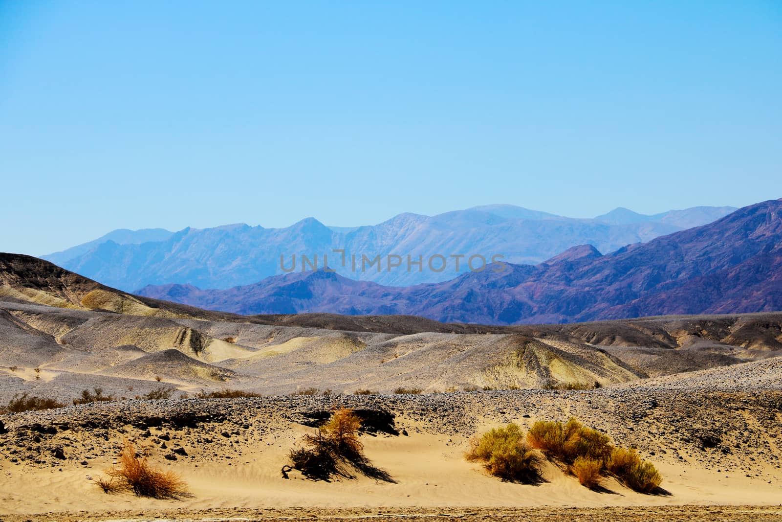 View of the dried mountain river in the background of mountains and sand