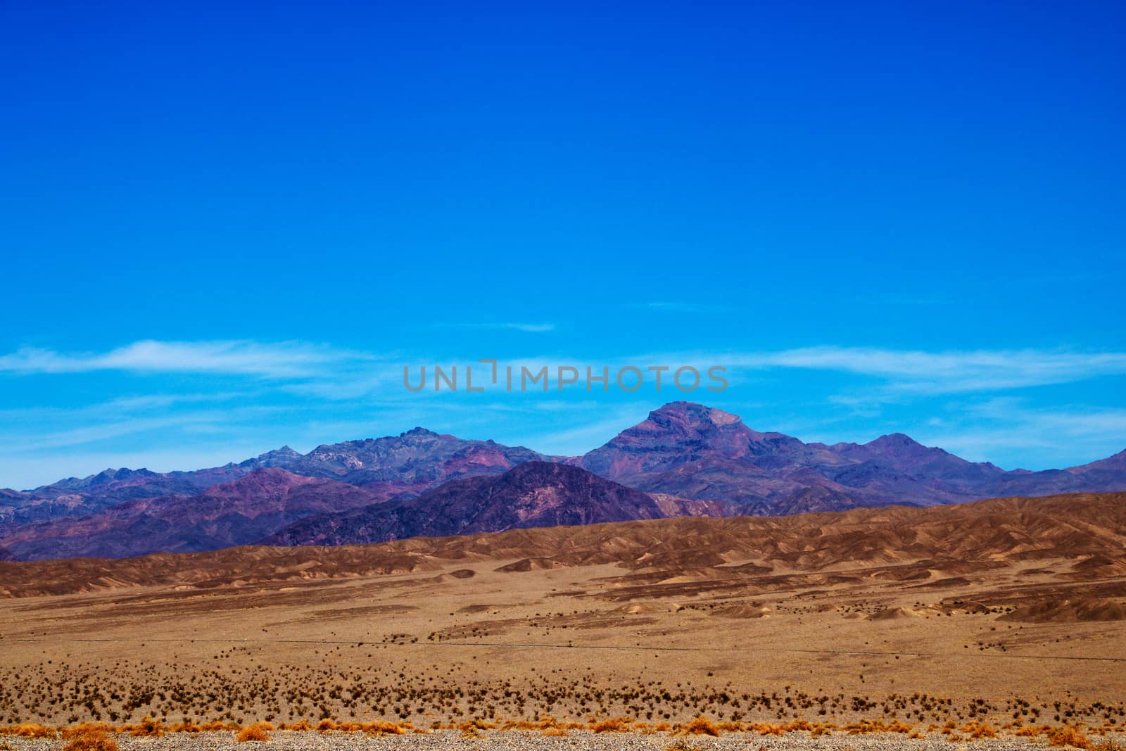 Different layers of Death Valley National Park with colorful mountains and sand dunes, USA. by kip02kas