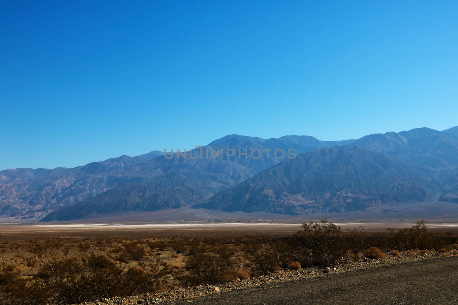 The road through Death Valley National Park, with the Panamint Mountains in the background. by kip02kas