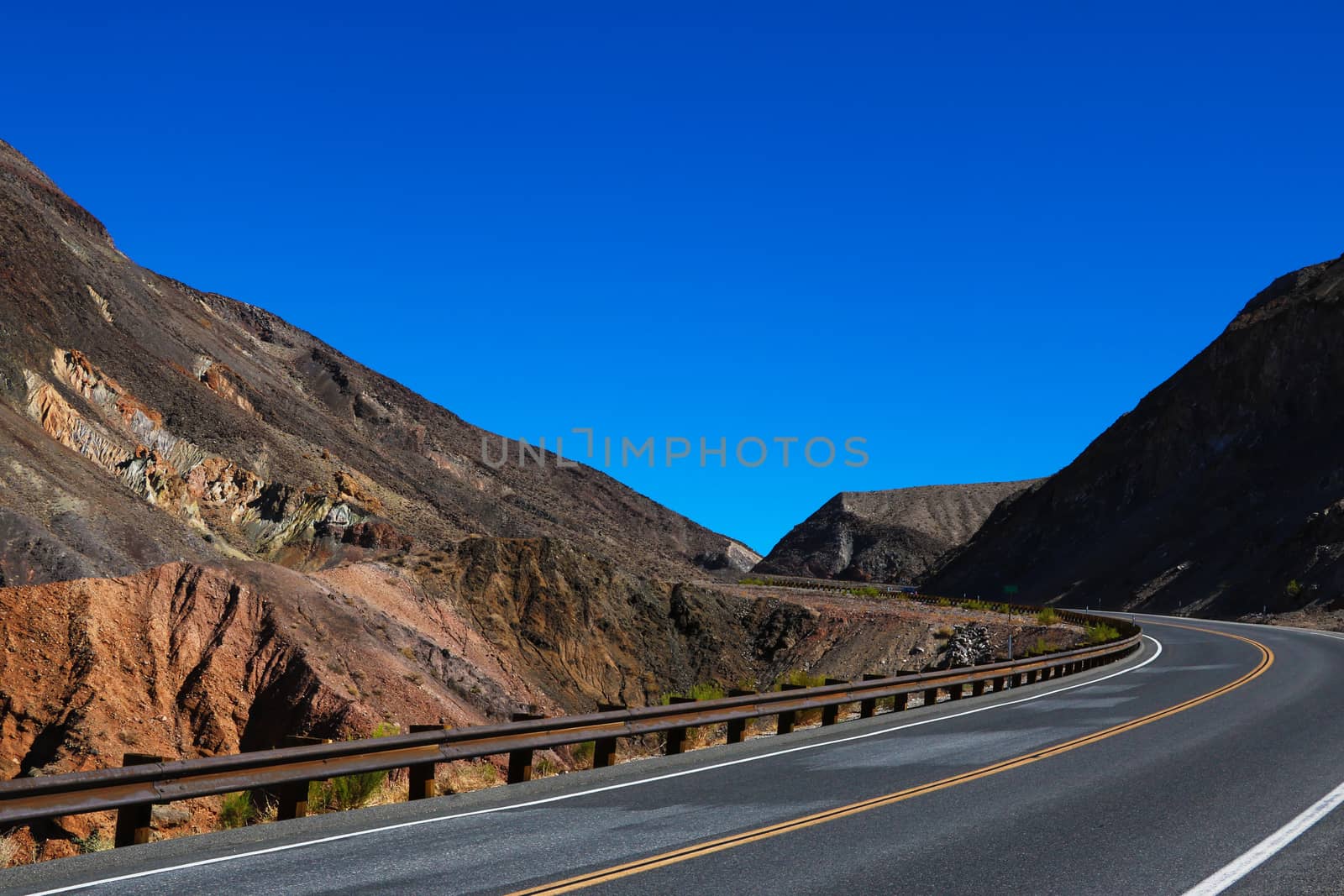 Classic panorama view of an endless straight road running through the barren scenery of the American Southwest. by kip02kas