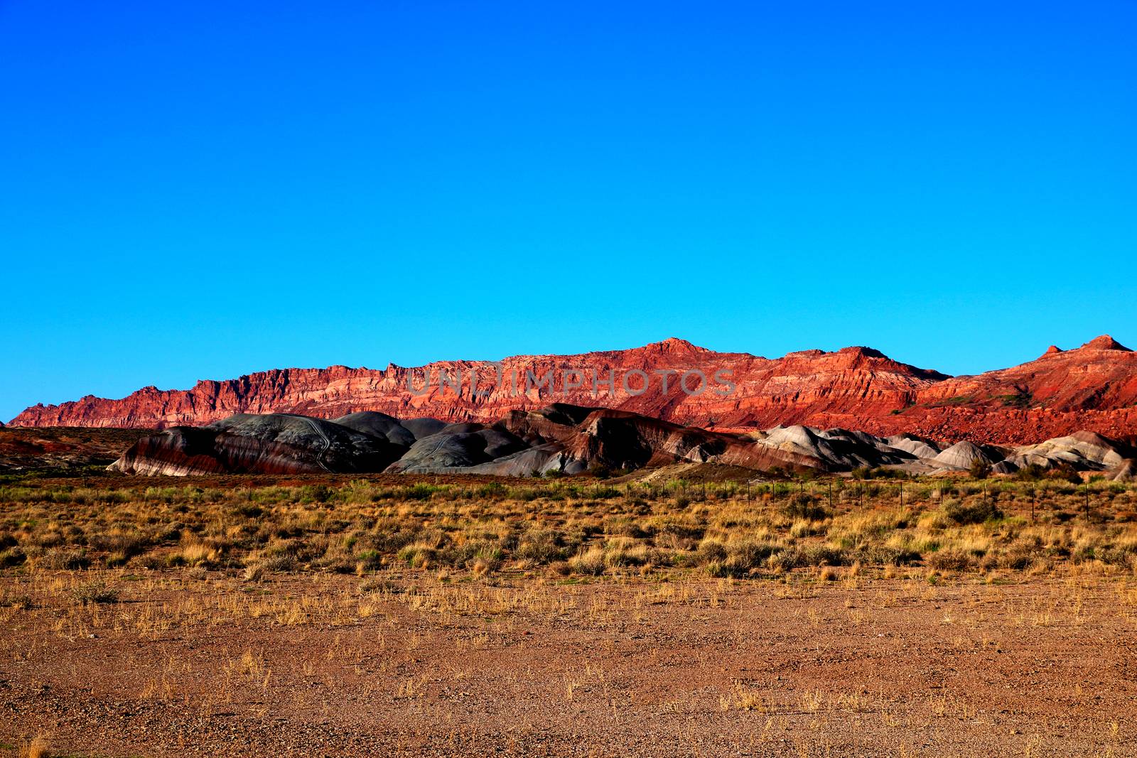 After a raw, gray day of wind-blown showers and flurries, the afternoon sky cleared and shone a beautiful light on the hills by Blue Mesa, in Painted Desert National Park.