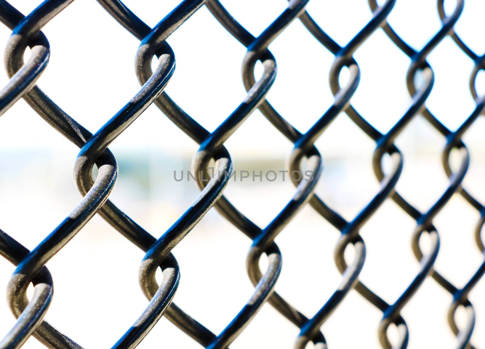 Close up mesh fence against the sky, background, pattern