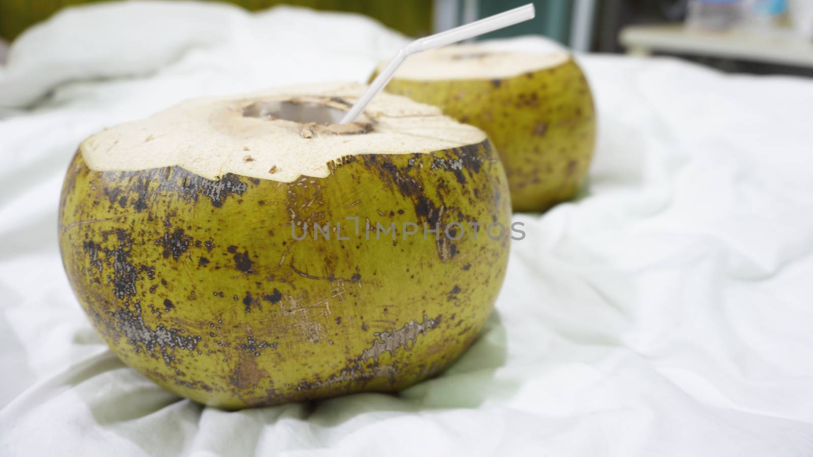 Fresh green coconut with straw ready to drinking by natali_brill